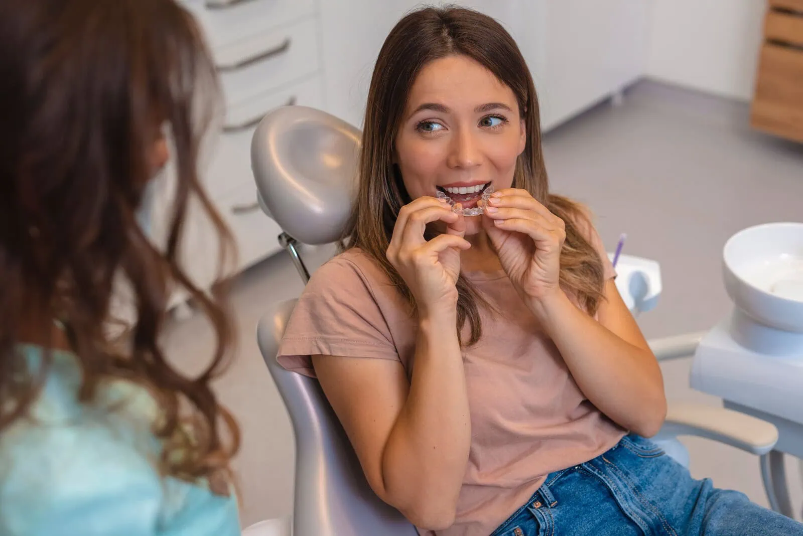 Dental assistant and patient reviewing a digital scan in the treatment chair